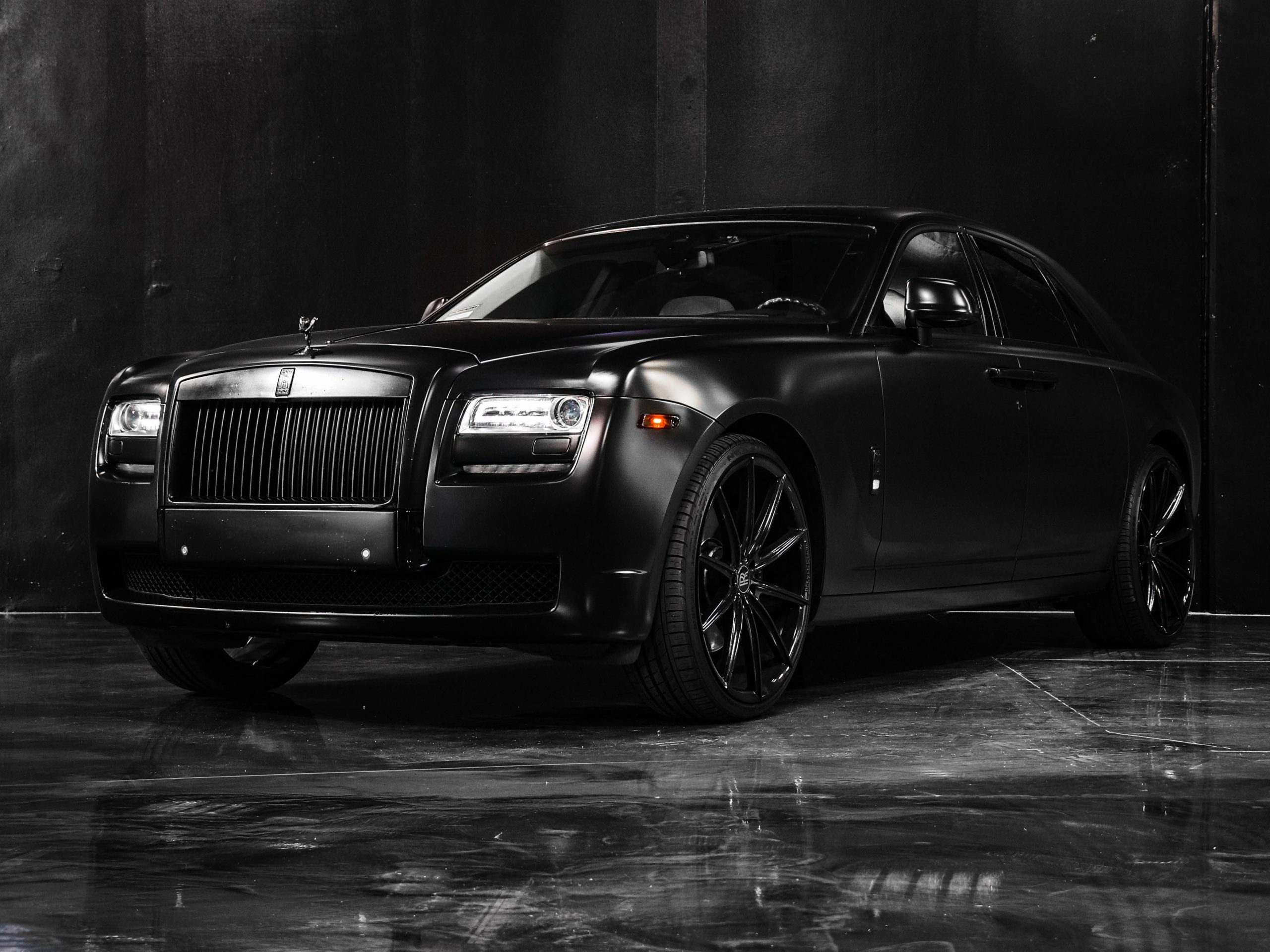 Black luxury car with glossy finish in a showroom