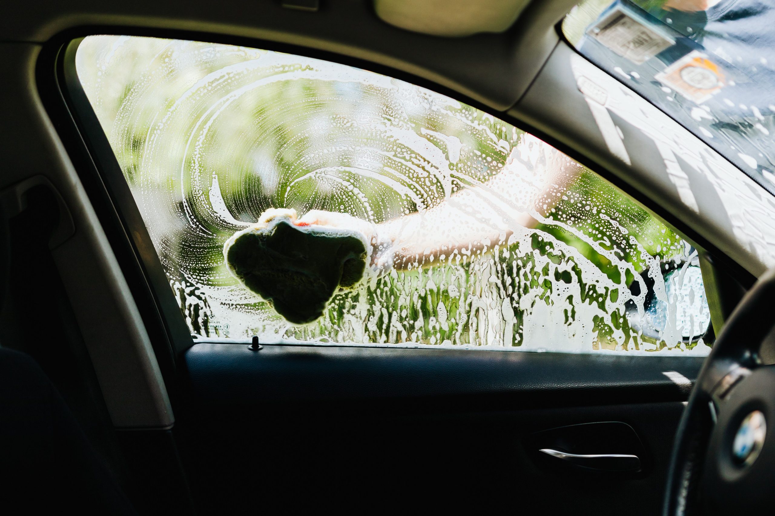Person washing a car window