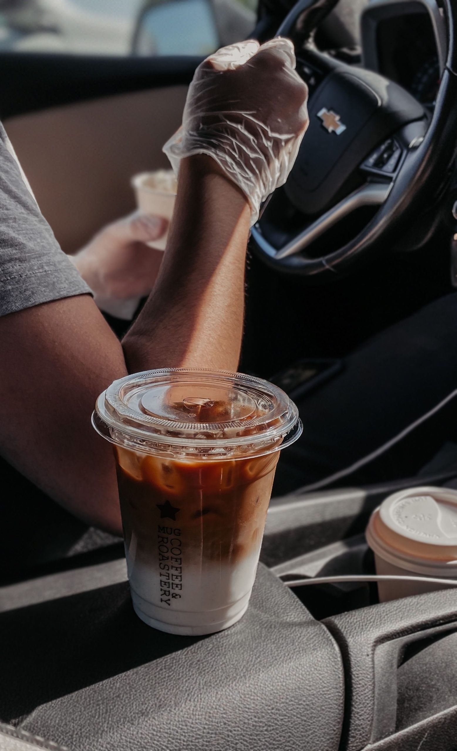 Cup of iced coffee inside a car