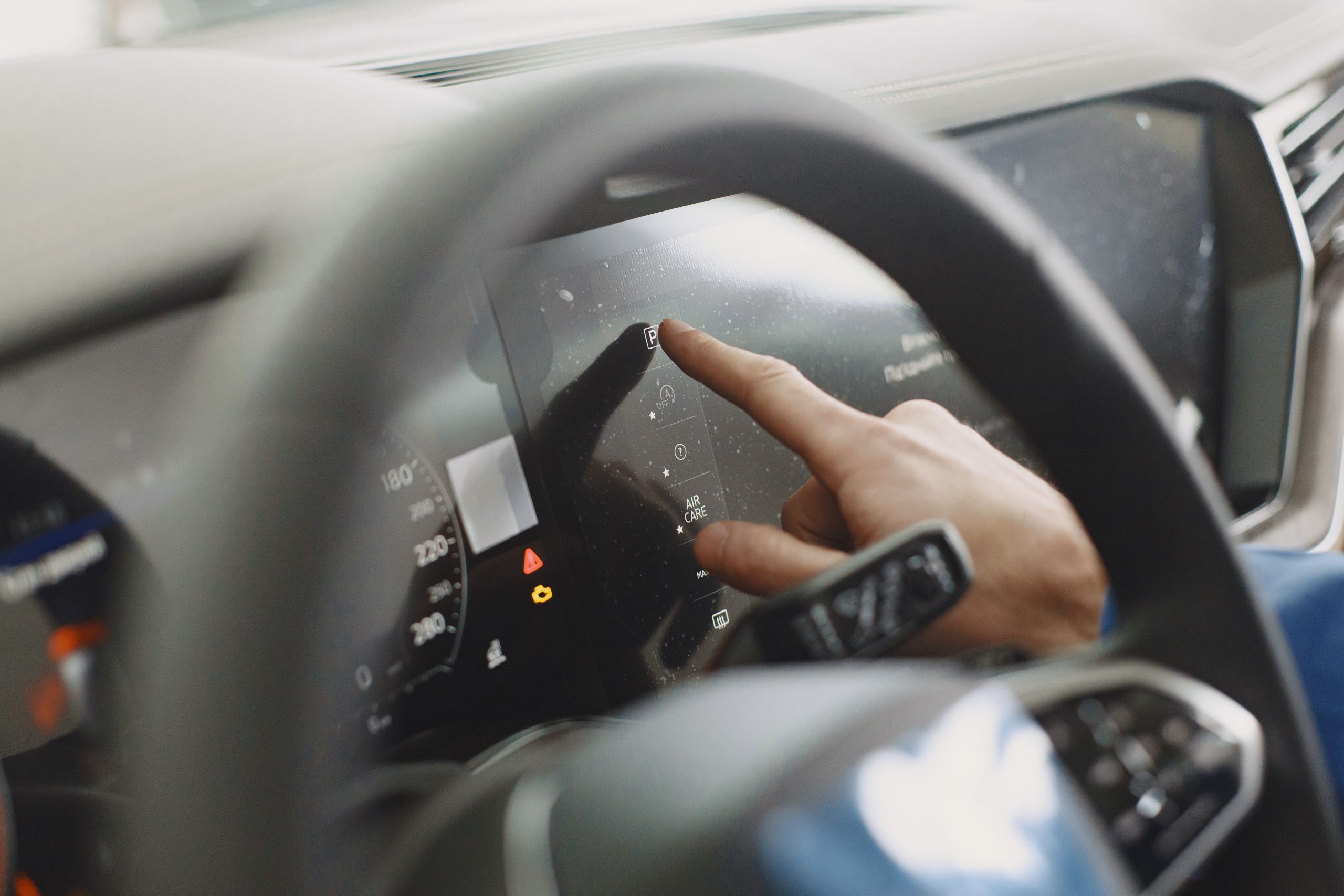 Person touching a car dashboard