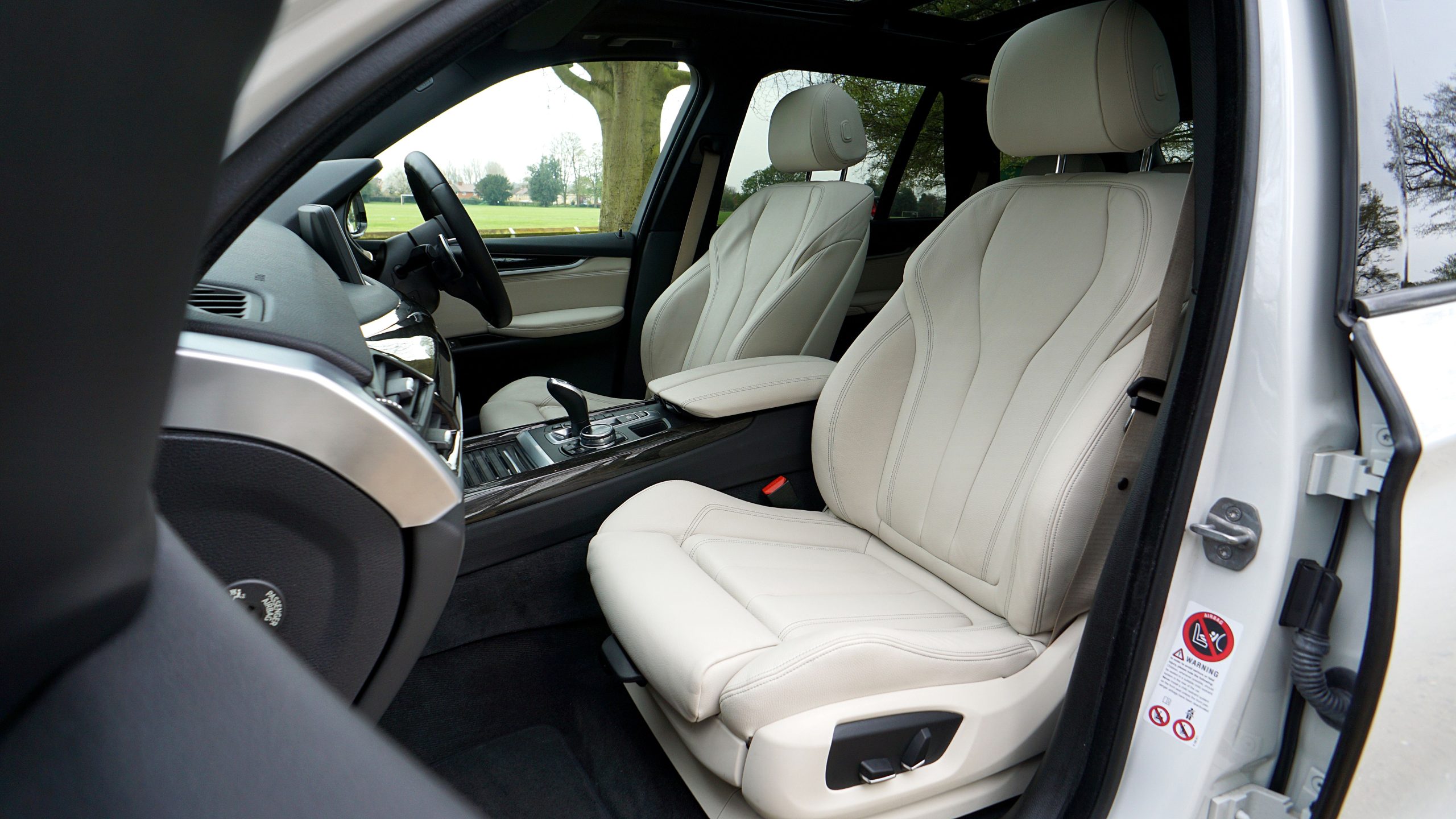 Luxury car interior with white leather seats
